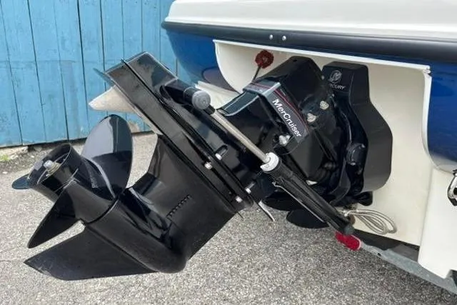 Slide: The Image of 2010 Bayliner 175 Bowrider boat with MerCruiser outboard motor, parked on pavement. - 6