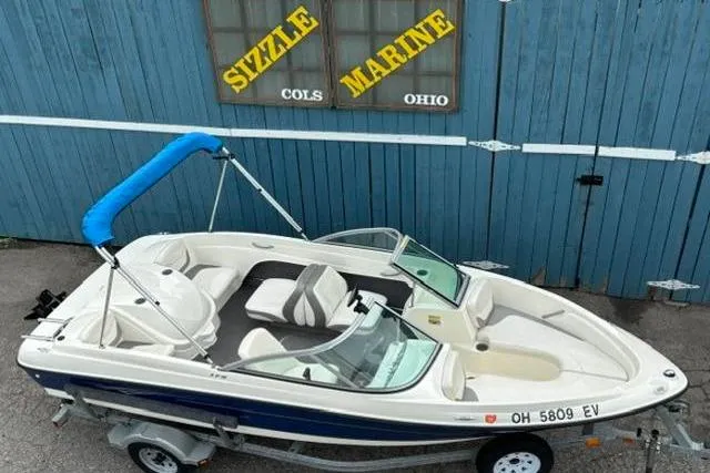 Slide: The Image of 2010 Bayliner 175 Bowrider boat with blue canopy, parked at Sizzle Marine, Ohio. - 7