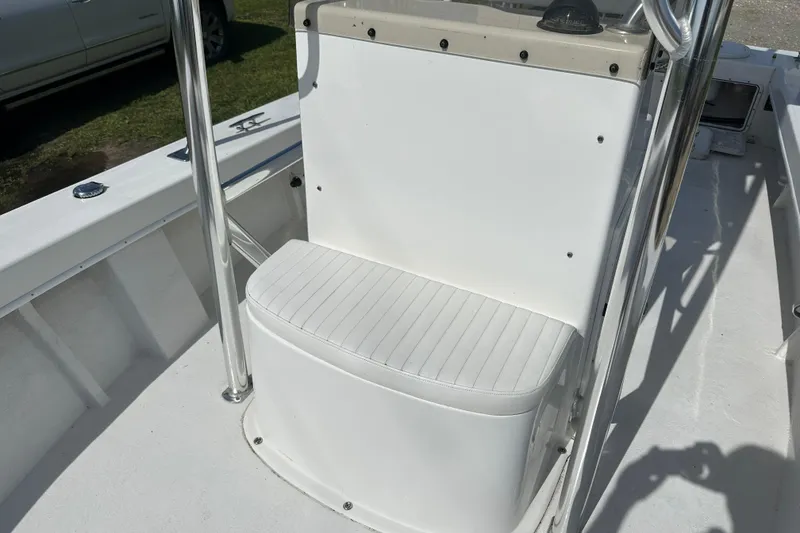 Slide: The Image of 2021 C-Hawk 23 Center Console boat seat with white upholstery and stainless steel frame. - 12