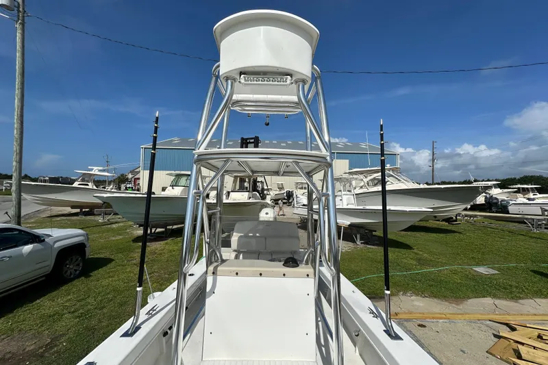 Slide: The Image of 2021 C-Hawk 23 Center Console boat with tower, parked outdoors under blue sky. - 16