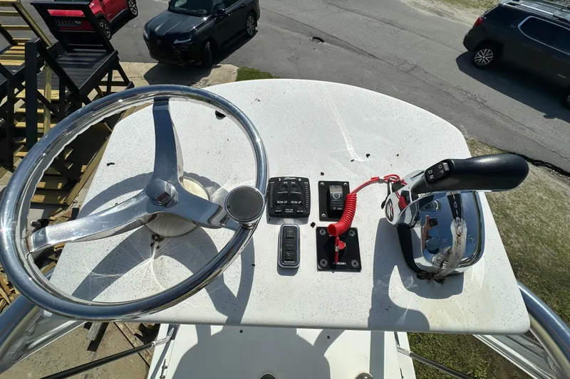 Slide: The Image of Steering console of 2021 C-Hawk 23 Center Console boat with controls and steering wheel. - 17