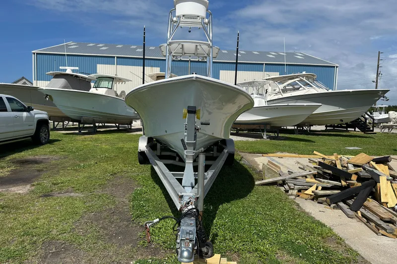 Slide: The Image of 2021 C-Hawk 23 Center Console boat on trailer, surrounded by other boats and a truck. - 2