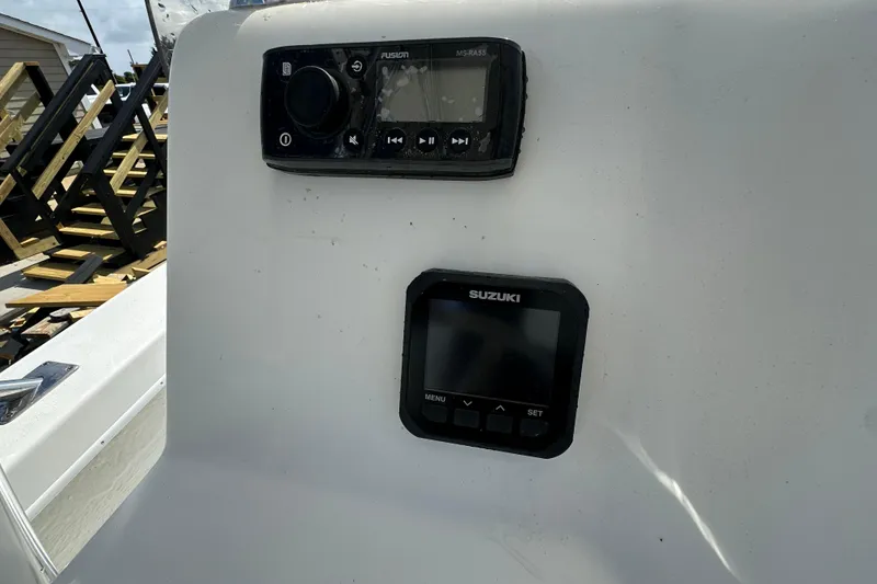 Slide: The Image of C-Hawk 23 Center Console 2021 dashboard with Fusion and Suzuki controls. - 22