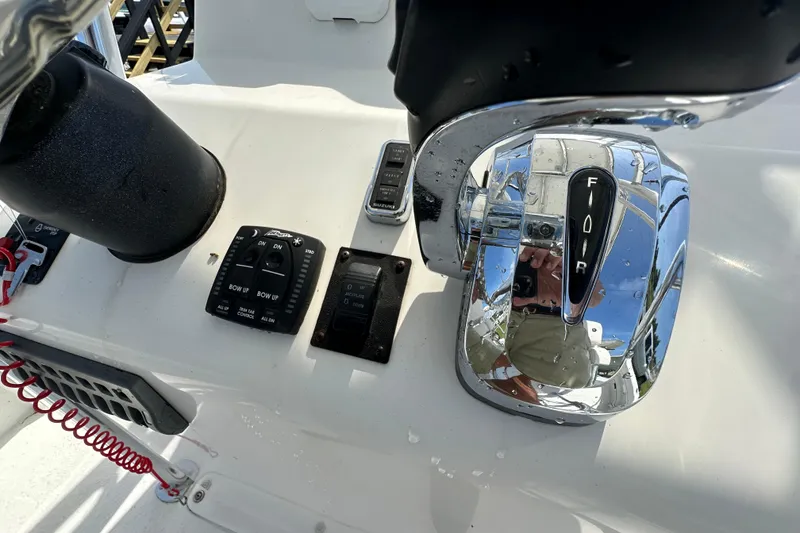 Slide: The Image of Close-up of 2021 C-Hawk 23 Center Console boat controls and throttle. - 23