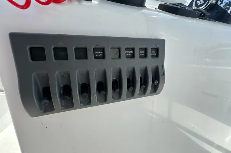 Slide: The Image of Control panel on a 2021 C-Hawk 23 Center Console boat with labeled switches. - 24