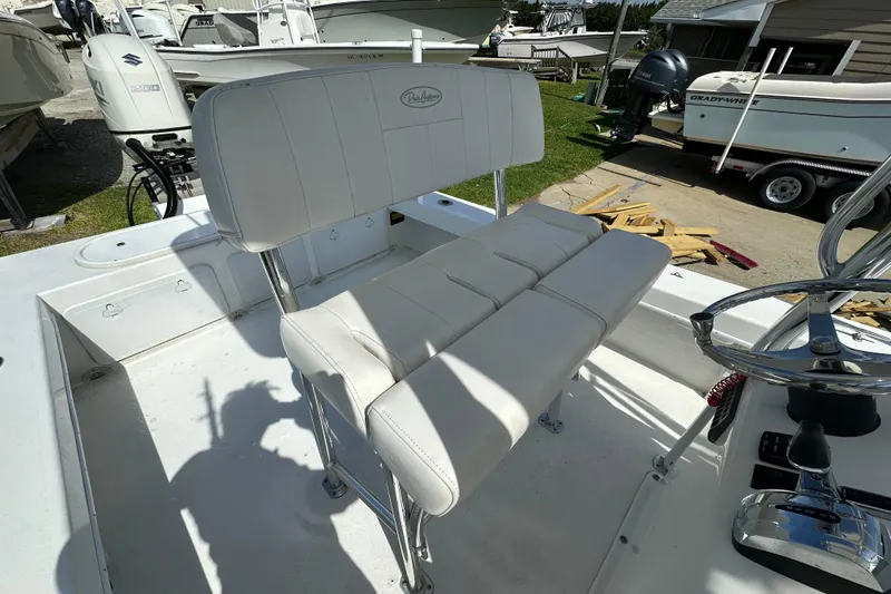 Slide: The Image of 2021 C-Hawk 23 Center Console boat with white seating and steering wheel. - 26