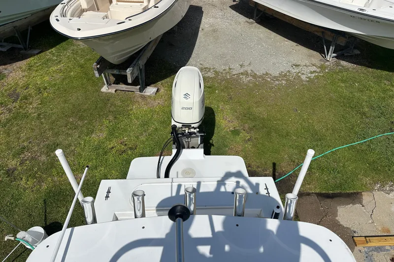 Slide: The Image of 2021 C-Hawk 23 Center Console boat with Suzuki 200 outboard engine, docked on grass. - 28
