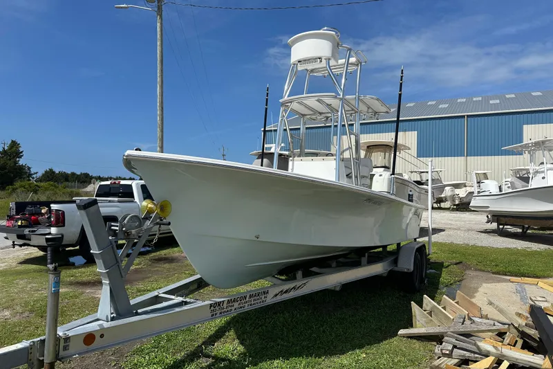 Slide: The Image of 2021 C-Hawk 23 Center Console boat on trailer, parked outdoors near marina. - 3