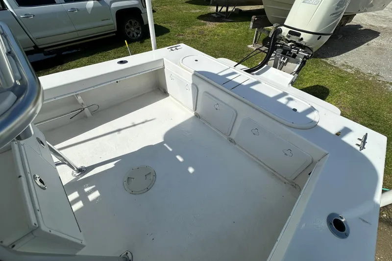 Slide: The Image of 2021 C-Hawk 23 Center Console boat interior with outboard motor and storage compartments. - 31