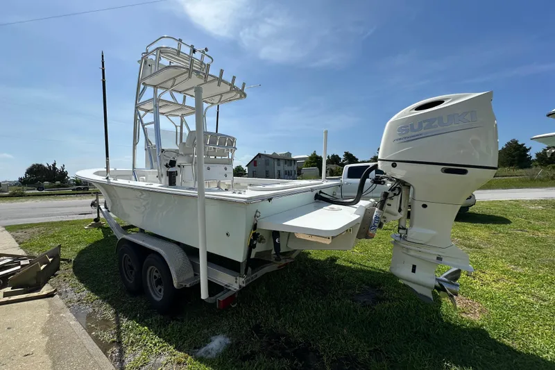 Slide: The Image of 2021 C-Hawk 23 Center Console boat with Suzuki outboard motor on trailer. - 6