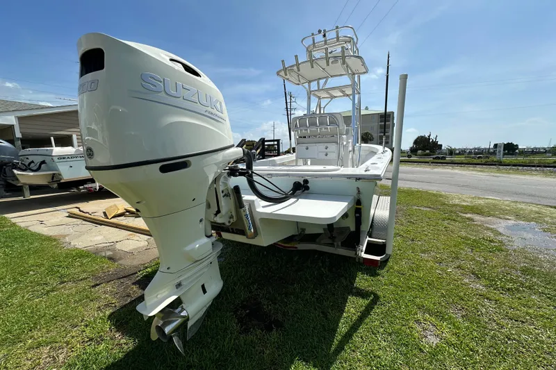 Slide: The Image of 2021 C-Hawk 23 Center Console boat with Suzuki outboard motor on grassy area. - 8