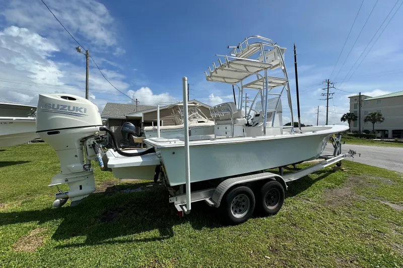 Slide: The Image of 2021 C-Hawk 23 Center Console boat with Suzuki outboard motor on trailer. - 9