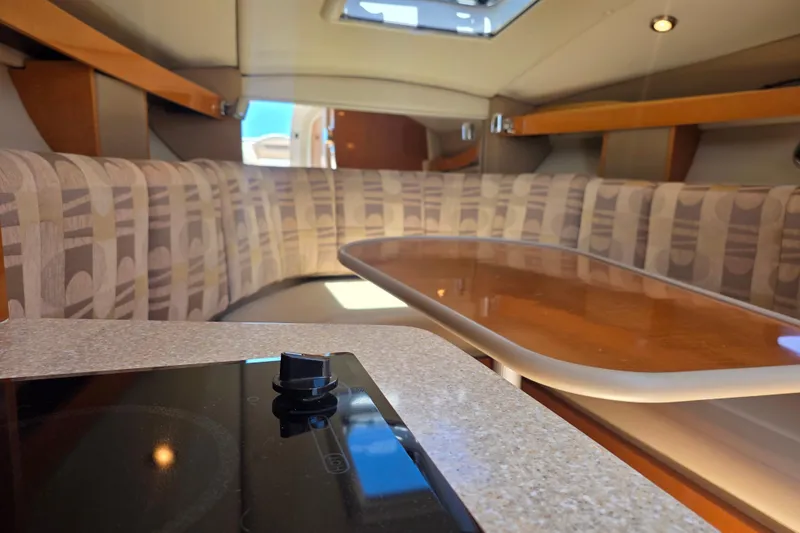 Slide: The Image of 2007 Chaparral Signature 250 interior with seating and table, featuring modern design elements. - 11