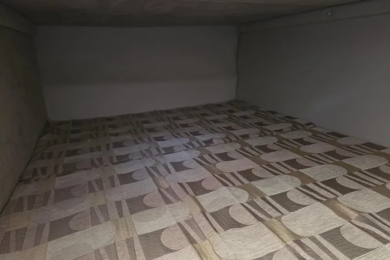 Slide: The Image of 2007 Chaparral Signature 250 cabin interior with patterned bedding. - 13