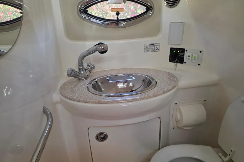 Slide: The Image of 2007 Chaparral Signature 250 boat bathroom with sink, faucet, and toilet. - 14