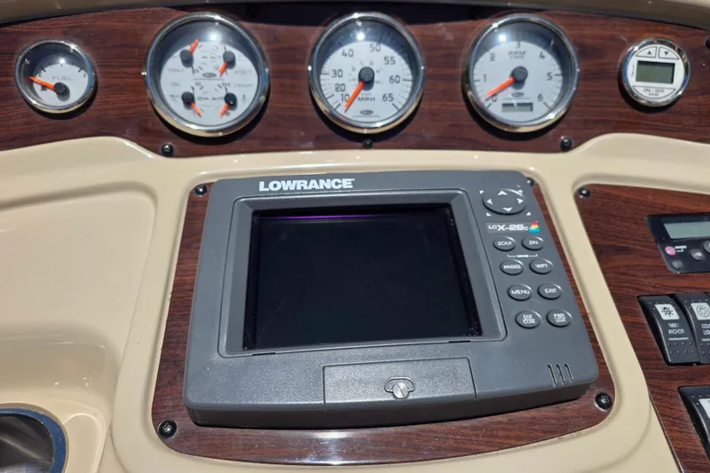 Slide: The Image of Dashboard of a 2007 Chaparral Signature 250 boat with gauges and Lowrance display. - 16