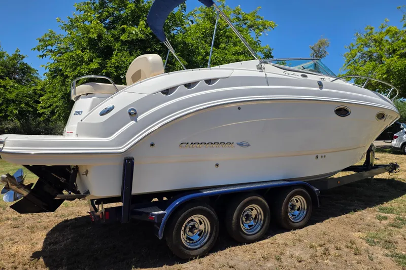 Slide: The Image of 2007 Chaparral Signature 250 boat on trailer, parked outdoors. - 4