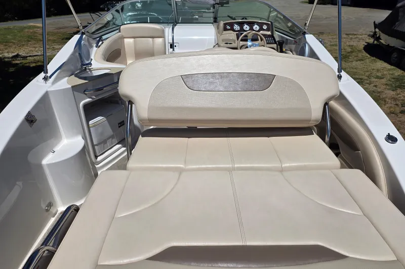 Slide: The Image of 2007 Chaparral Signature 250 boat interior with beige seating and dashboard view. - 8