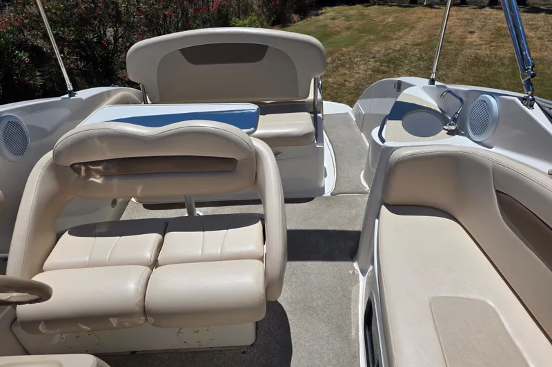Slide: The Image of 2007 Chaparral Signature 250 boat interior with beige seating and outdoor speakers. - 9