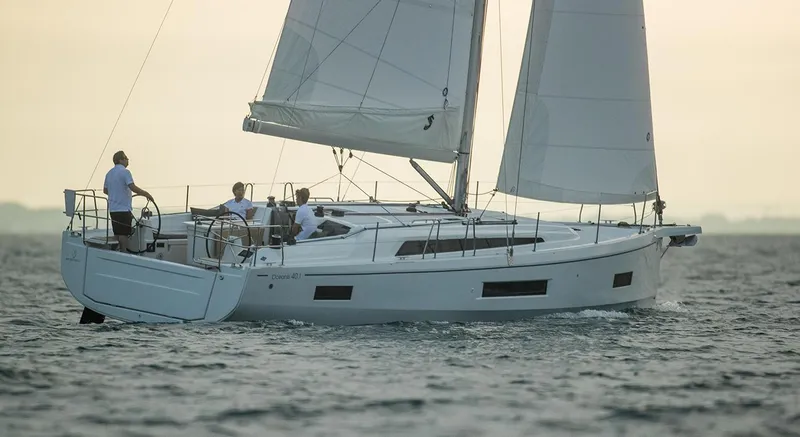 The Image of 2026 Beneteau Oceanis 40.1 sailing yacht on open water at sunset. - 0