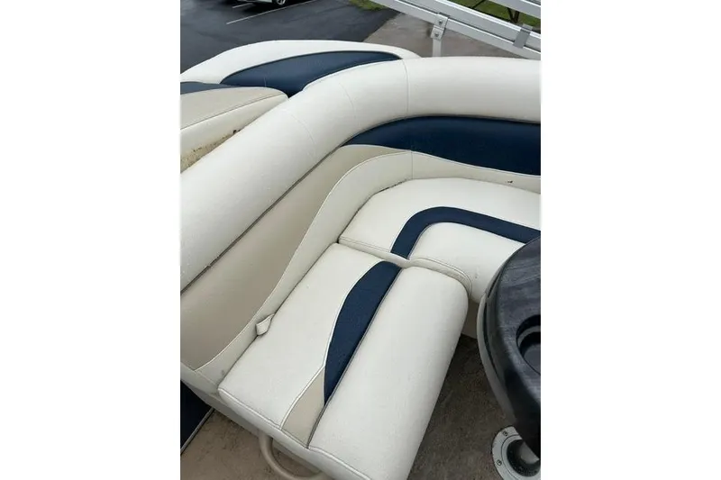 Slide: The Image of 2015 Godfrey Sweetwater 1880 CX boat interior with beige and navy seating. - 11