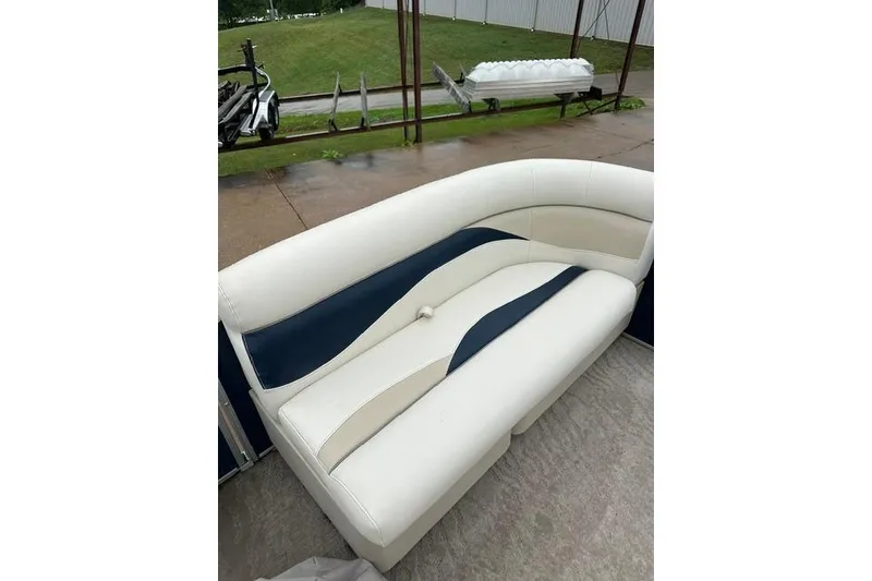 Slide: The Image of 2015 Godfrey Sweetwater 1880 CX boat seating, white and navy upholstery, outdoor setting. - 14