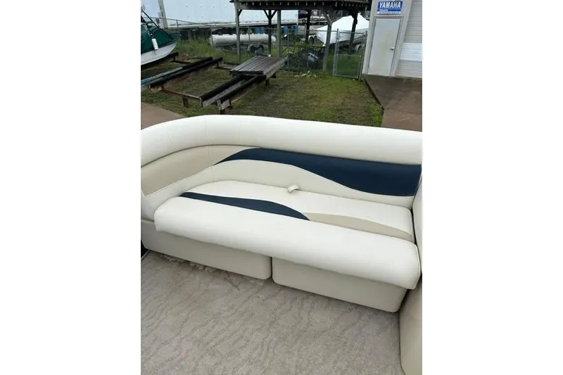 Slide: The Image of 2015 Godfrey Sweetwater 1880 CX boat seating with beige and navy upholstery. - 15