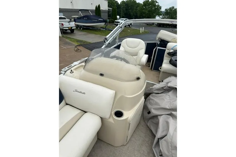 Slide: The Image of 2015 Godfrey Sweetwater 1880 CX pontoon boat interior with beige seating and console. - 16