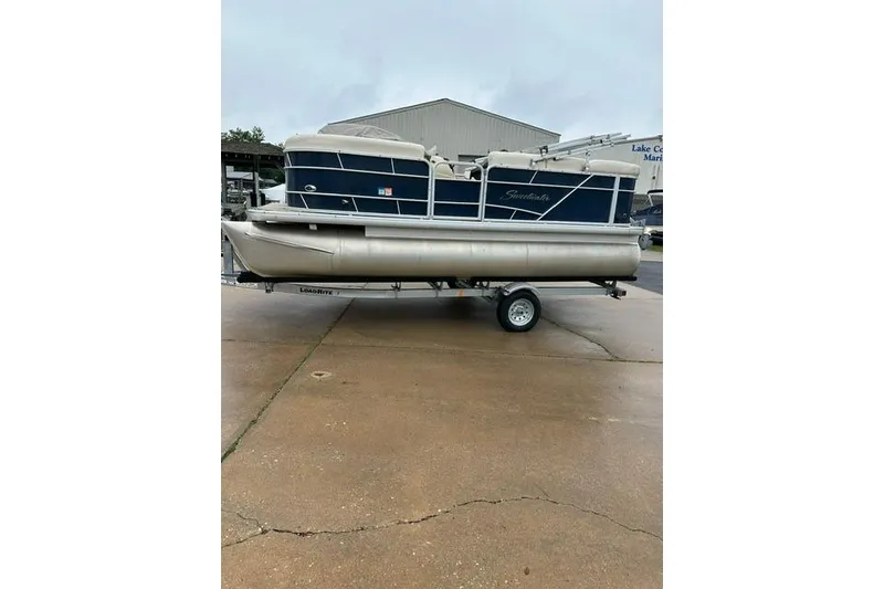 Slide: The Image of 2015 Godfrey Sweetwater 1880 CX pontoon boat on trailer, parked outdoors. - 2