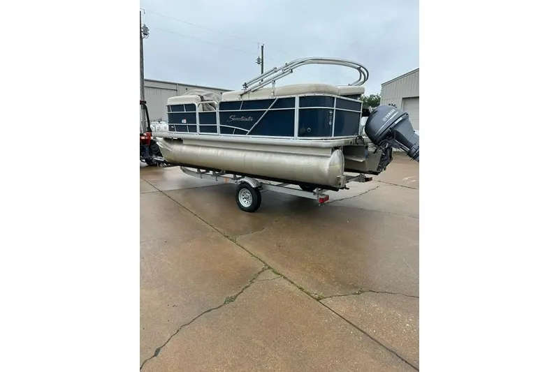 Slide: The Image of 2015 Godfrey Sweetwater 1880 CX pontoon boat on trailer, parked outdoors. - 3