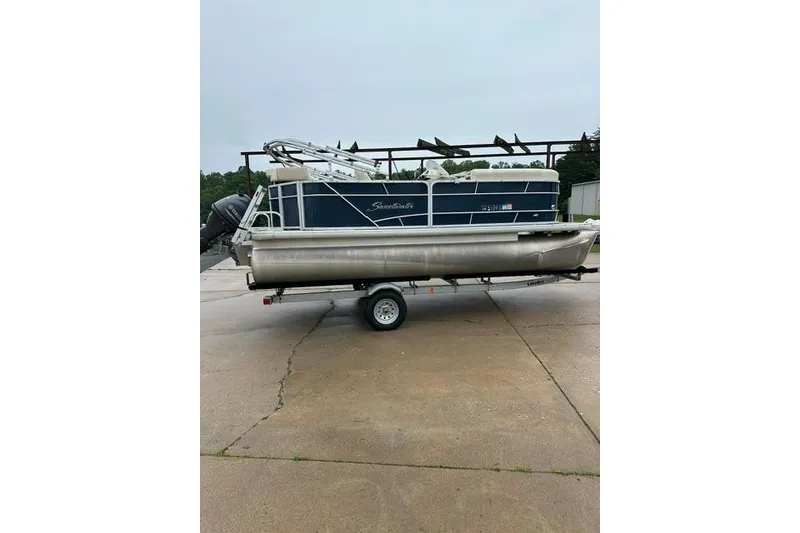 Slide: The Image of 2015 Godfrey Sweetwater 1880 CX pontoon boat on trailer, parked outdoors. - 6