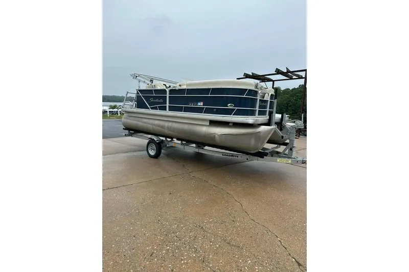 Slide: The Image of 2015 Godfrey Sweetwater 1880 CX pontoon boat on trailer, parked outdoors. - 7