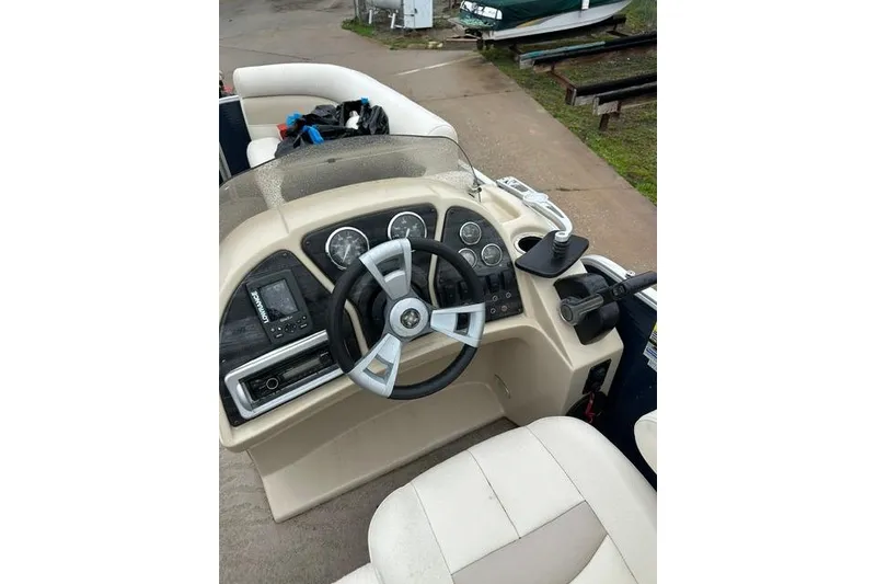 Slide: The Image of 2015 Godfrey Sweetwater 1880 CX boat dashboard with steering wheel and controls. - 9