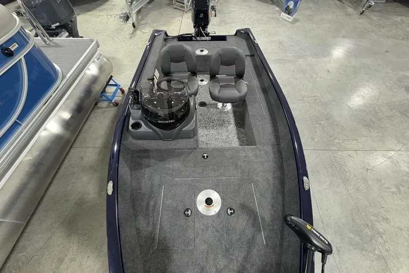 Slide: The Image of 2026 Tracker Super Guide V-16 SC boat interior with seating and control console. - 18
