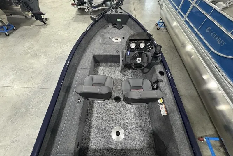 Slide: The Image of 2026 Tracker Super Guide V-16 SC boat interior with dual seats and steering console. - 19
