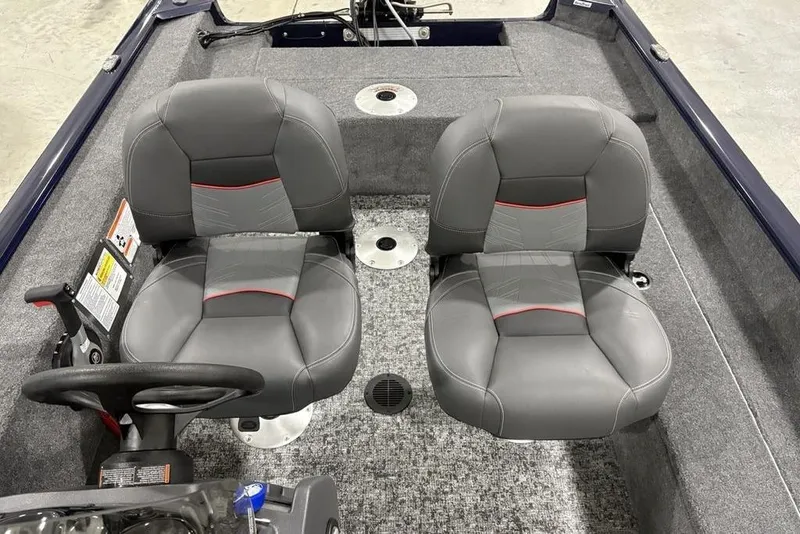Slide: The Image of 2026 Tracker Super Guide V-16 SC boat interior with dual gray seats and steering console. - 22