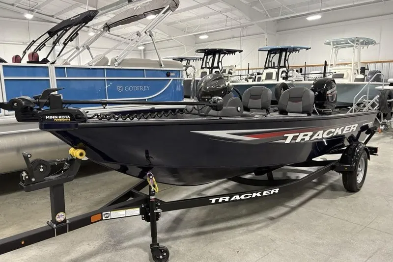 Slide: The Image of 2026 Tracker Super Guide V-16 SC fishing boat in showroom, featuring Minn Kota motor. - 3