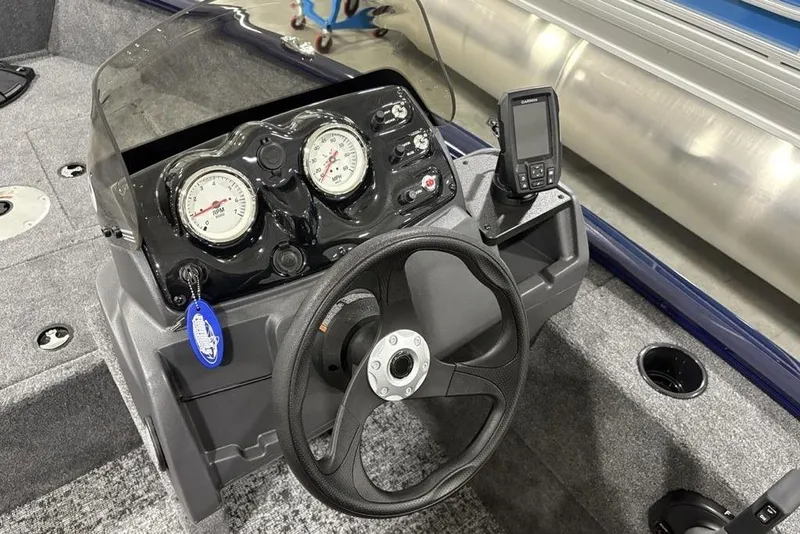 Slide: The Image of 2026 Tracker Super Guide V-16 SC boat dashboard with steering wheel and gauges. - 8