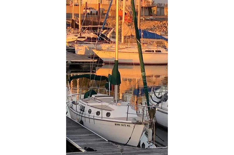 The Image of Sailboat Com-Pac 25, 1995 model, docked at marina during sunset. - 1
