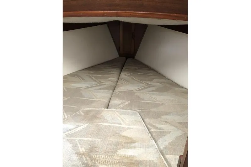 Slide: The Image of Interior cabin view of a 1995 Com-Pac 25 sailboat with patterned cushions. - 10