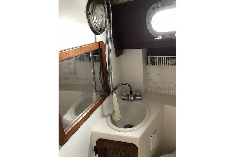 Slide: The Image of Compact bathroom sink area in a 1995 Com-Pac 25 sailboat. - 16