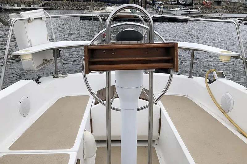 Slide: The Image of Cockpit of a 1995 Com-Pac 25 sailboat with steering wheel and seating. - 3