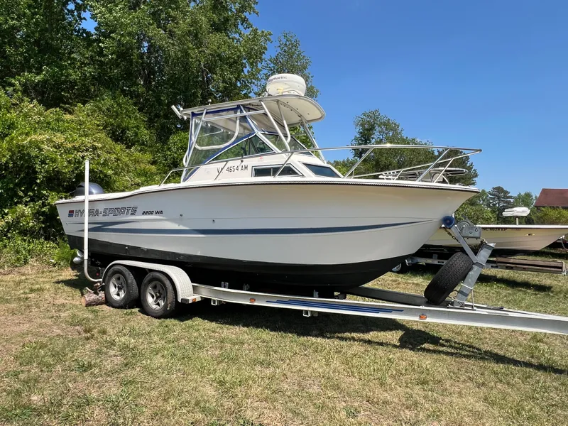The Image of 1990 Hydra-Sports 2200 WA boat on trailer outdoors. - 0