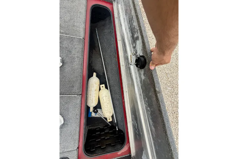 Slide: The Image of 2021 Tracker Pro Team 195 TXW boat storage compartment with fenders and equipment. - 10