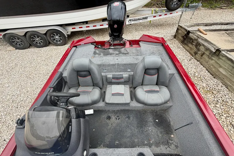 Slide: The Image of 2021 Tracker Pro Team 195 TXW boat interior with gray seating and steering console. - 13