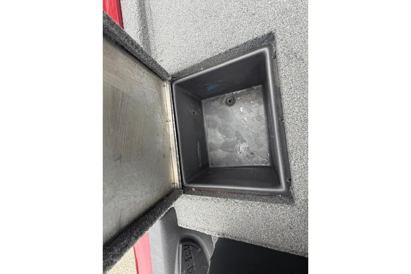 Slide: The Image of Open storage compartment in 2021 Tracker Pro Team 195 TXW boat. - 17