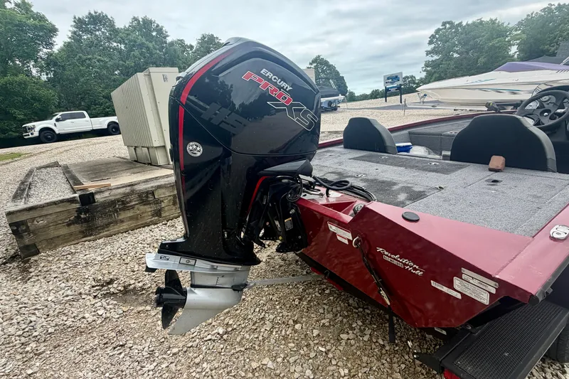 Slide: The Image of 2021 Tracker Pro Team 195 TXW boat with powerful outboard motor in a gravel lot. - 7