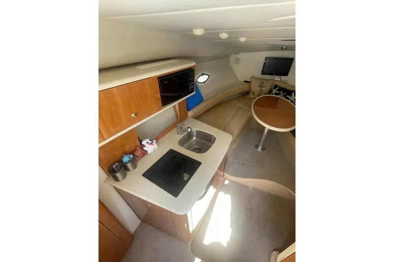 Slide: The Image of Interior of 2002 Maxum 2700 SCR boat with kitchenette and seating area. - 10