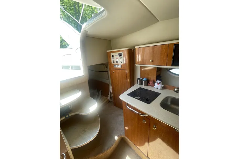 Slide: The Image of Interior of 2002 Maxum 2700 SCR boat with kitchenette and storage cabinets. - 11