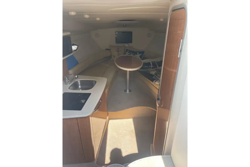 Slide: The Image of Interior of 2002 Maxum 2700 SCR boat with kitchenette and seating area. - 13